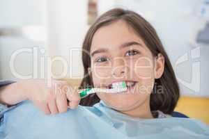Smiling young patient holding touthbrush