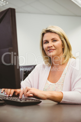 Mature student using laptop looking at camera