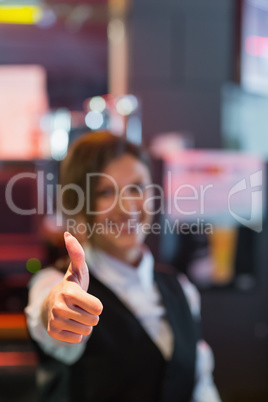 Barmaid showing thumbs up to camera