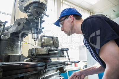 Engineering student using large drill