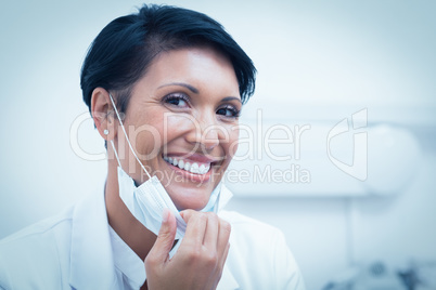 Confident female dentist smiling