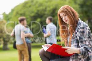 Pretty student studying outside on campus