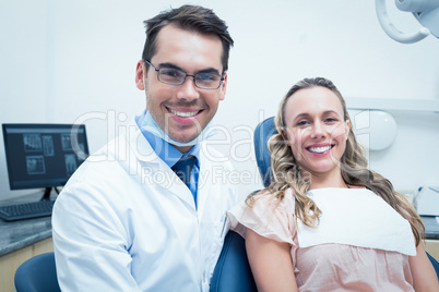 Dentist examining young womans teeth