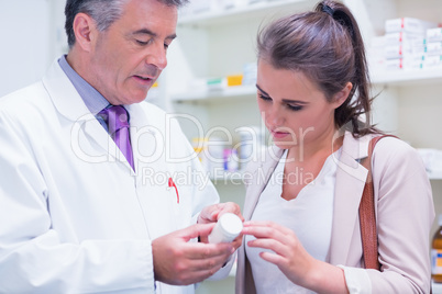 Pharmacist explaining something to a customer