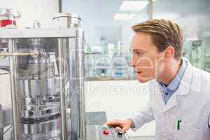 Focused pharmacist using advanced technology