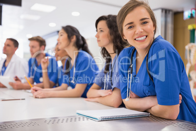 Medical student smiling at the camera during class