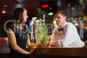 Handsome barman serving champagne to customer