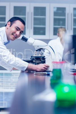 Science student working with microscope in the lab