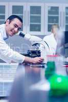 Science student working with microscope in the lab