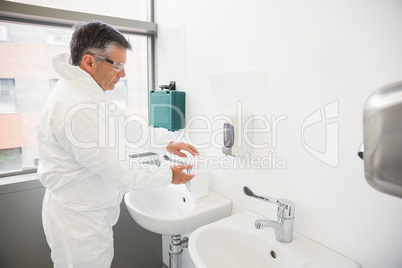 Pharmacist washing his hands at sink