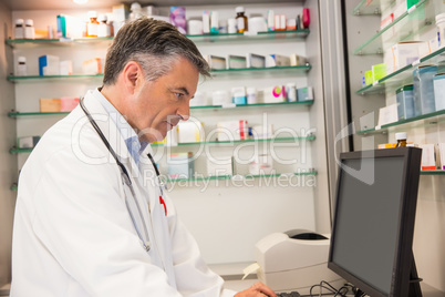 Focused pharmacist using the computer