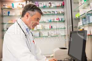 Focused pharmacist using the computer