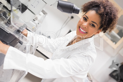 Pretty science student using microscope