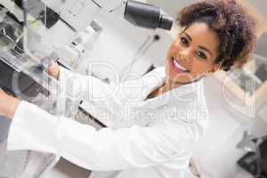 Pretty science student using microscope