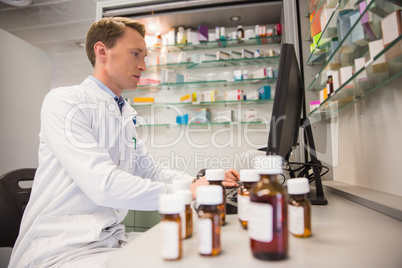 Pharmacist using computer at desk