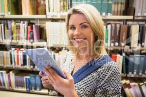 Mature student using tablet in library