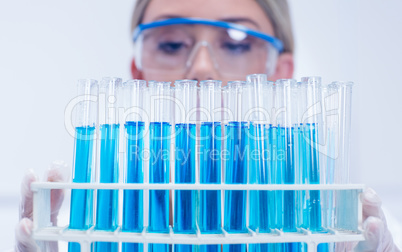 Science student holding tray of test tubes