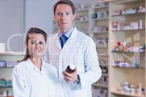 Pharmacist showing medication to his trainee