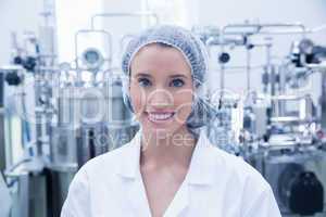 Portrait of a smiling scientist wearing hair net