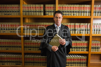 Lawyer holding book in the law library