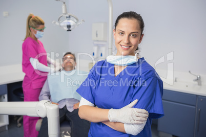 Smiling dentist with arms crossed