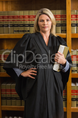 Lawyer holding book in the law library