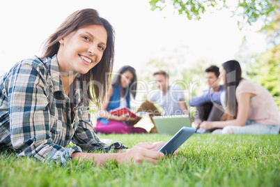 Happy students sitting outside on campus