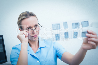 Female dentist looking at x-ray