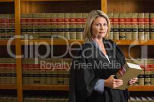 Lawyer holding book in the law library