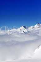 Mountains in clouds at nice winter day