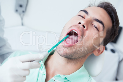 Close up of man having his teeth examined