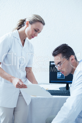 Side view of dentists discussing reports