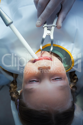 Close up of girl having her teeth examined