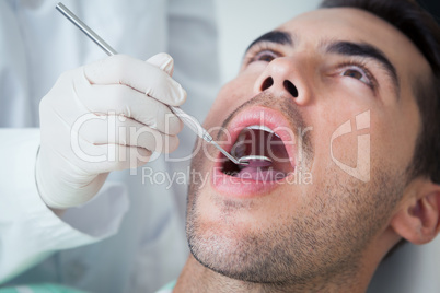 Close up of man having his teeth examined