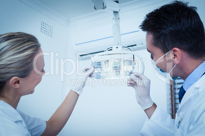 Dentists looking at x-ray