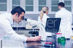 Science student working with microscope in the lab