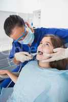 Pediatric dentist wearing safety glasses