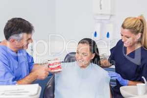 Dentist and nurse explaining to their patient how use toothbrush