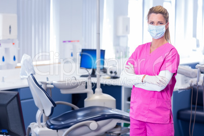 Dentist in surgical mask standing with arms crossed Dentist in surgical mask standing with arms crossed