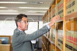 Lawyer picking book in the law library