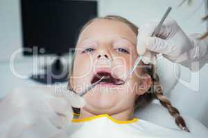 Close up of girl having her teeth examined