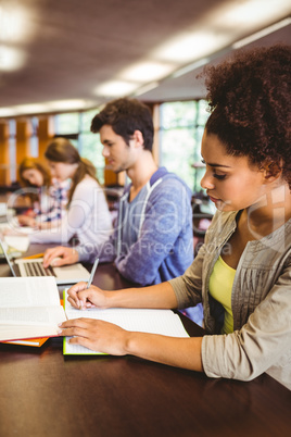 Focused students sitting in a line writing