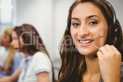 Smiling call centre agent talking on the headset