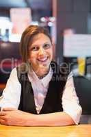 Pretty barmaid smiling at camera