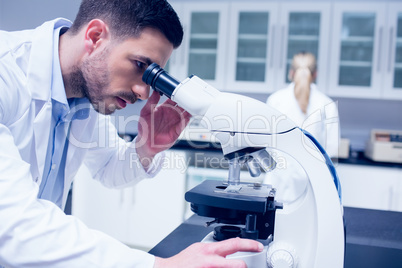 Science student working with microscope in the lab