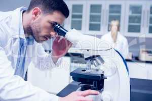 Science student working with microscope in the lab