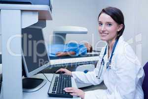 Smiling doctor with stethoscope in radiography room