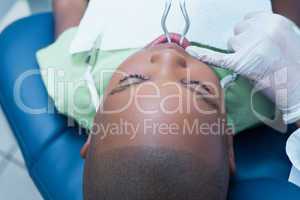 Boy having his teeth examined by dentist