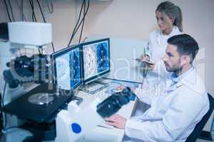 Science students looking at microscopic images