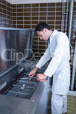 Focused brewer working at machine